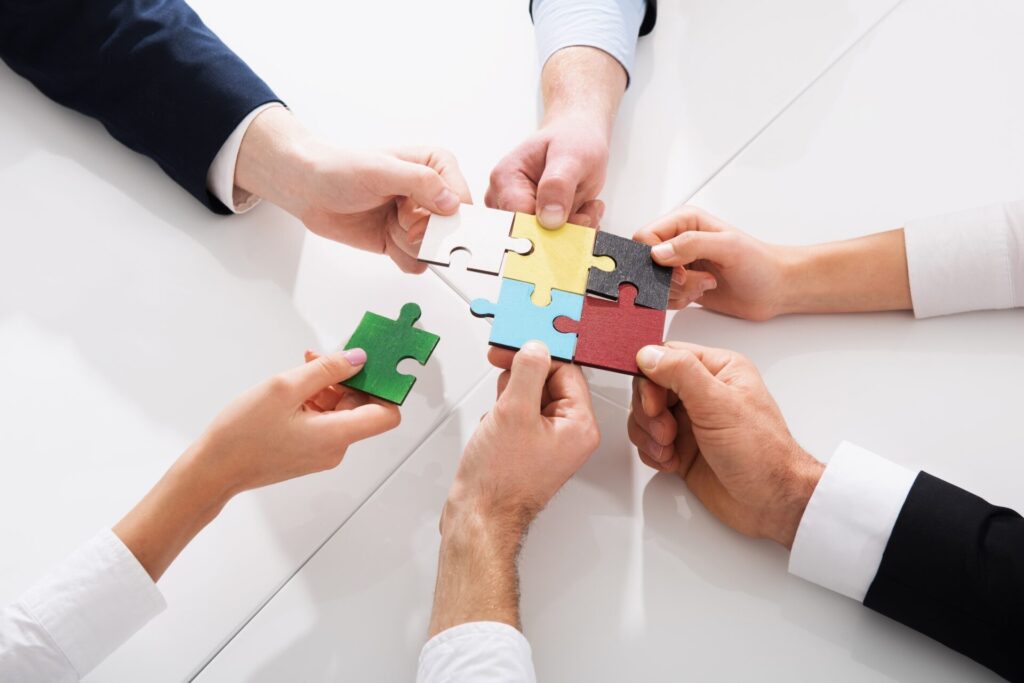 Teamwork of partners. Concept of integration and startup with puzzle pieces